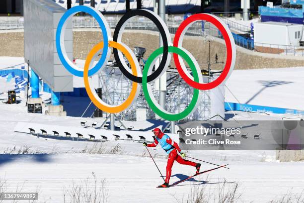 Athlete skis past a Olympic rings logo during the Cross-Country Skiing training session ahead of Beijing 2022 Winter Olympic Games at The National...