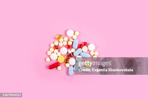 Different pills on pink background. Close-up. Different pills on pink background. Close-up.
