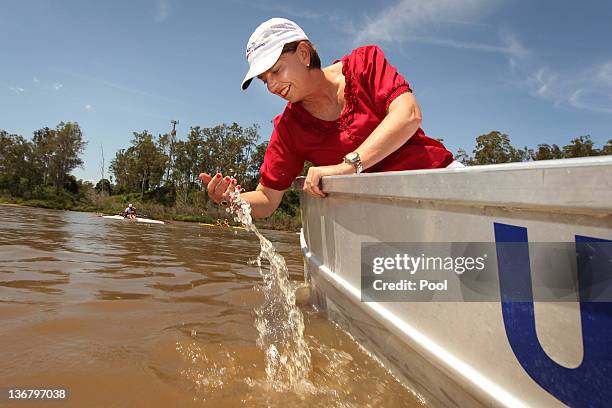 Queensland Premier Anna Bligh rides on a boat on the Brisbane River after visiting members of the Centenary Rowing Club which was hard hit by the...