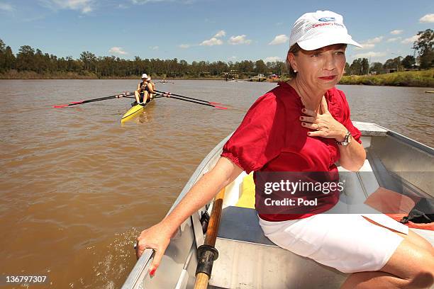 Queensland Premier Anna Bligh rides on a boat on the Brisbane River after visiting members of the Centenary Rowing Club which was hard hit by the...
