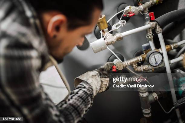 heating engineer fixing modern heating system. - bathroom closeup stock pictures, royalty-free photos & images