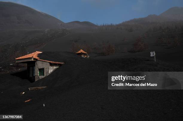 Residential house is seen isolated and covered by volcanic ashes and lava on January 31, 2022 in La Palma, Spain. Spain's Cumbre Vieja volcano began...