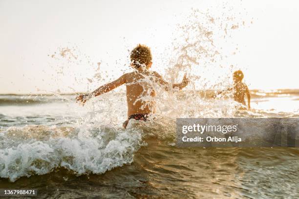boys playing at the beach - asturias stock pictures, royalty-free photos & images