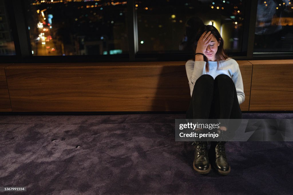 Teenage girl crying beacuse of the cyberbullying