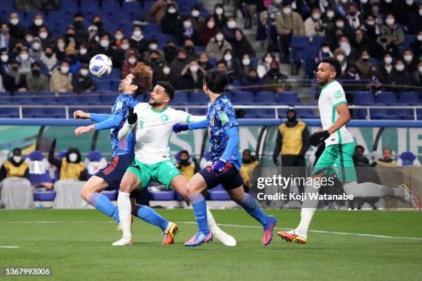 Yuya Osako of Japan is challenged by Abdulelah Alamri of Saudi Arabia during the FIFA World Cup Asian Qualifier Final Round Group B match between...