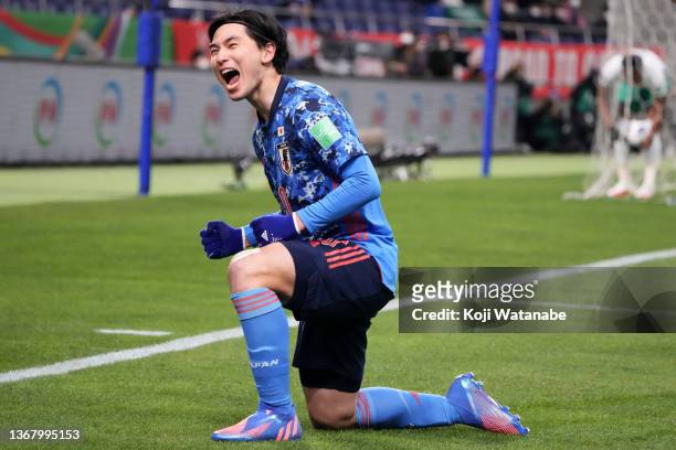 Takumi Minamino of Japan celebrates scoring his side's first goal during the FIFA World Cup Asian Qualifier Final Round Group B match between Japan...