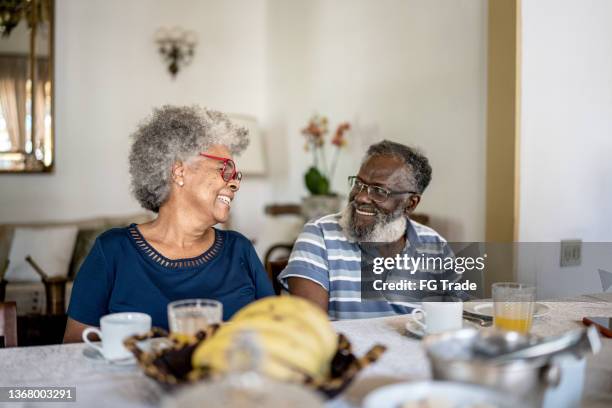 happy senior couple having breakfast together - woman normal old diverse stock pictures, royalty-free photos & images