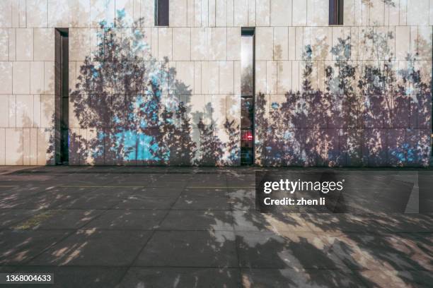 empty parking lot covered with shade - wall night stock-fotos und bilder