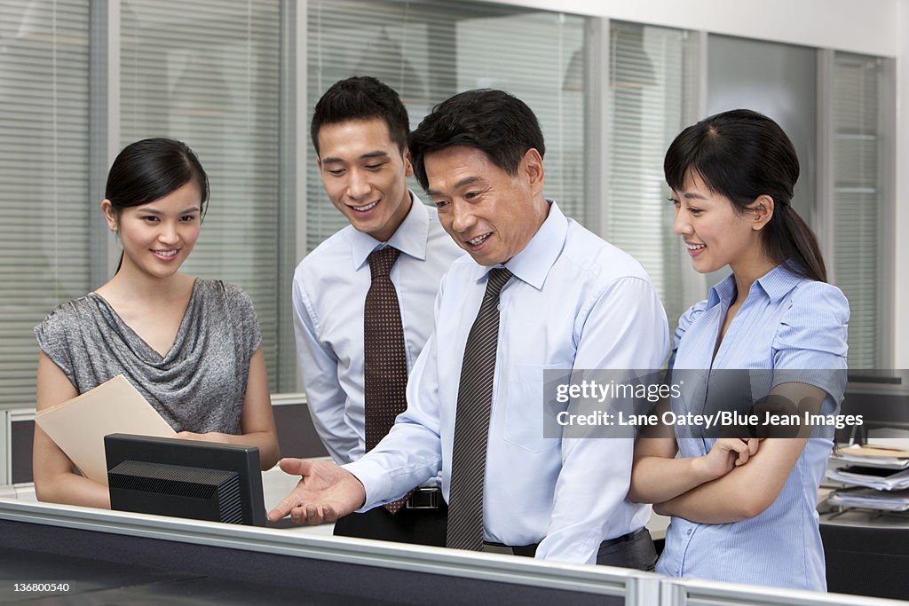 Senior Colleague Helping Co-workers