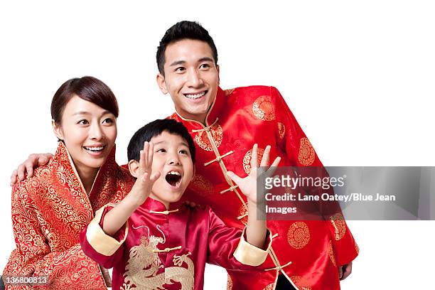 family dressed in traditional clothing  celebrating chinese new year - child giving brother a new haircut stock-fotos und bilder