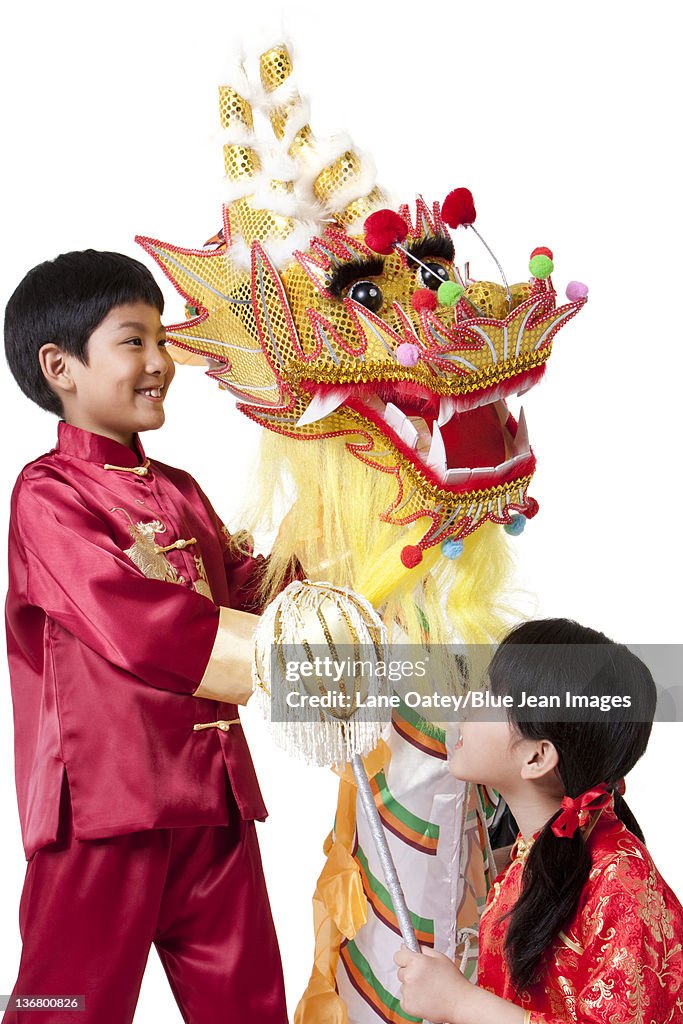 Boy and Girl Dressed in Traditional Clothing Celebrating Chinese New Year