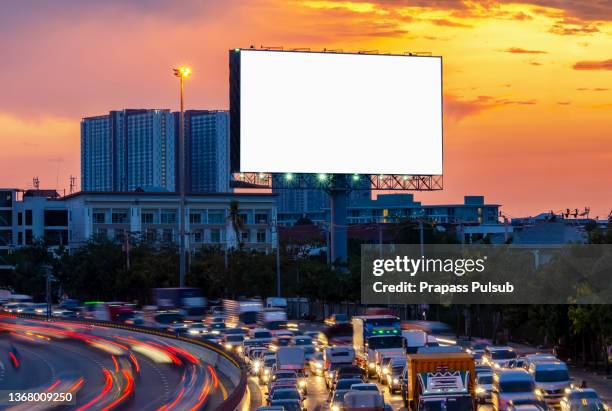 blank billboard on city street at night. outdoor advertising - billboard night photos et images de collection