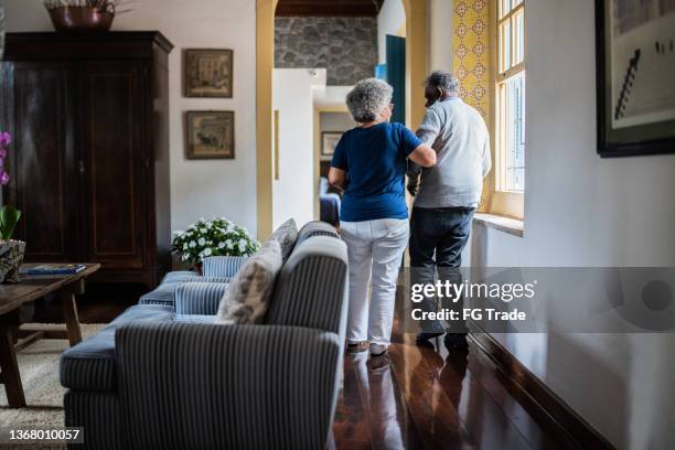 wife helping husband walking at home - husband stock pictures, royalty-free photos & images