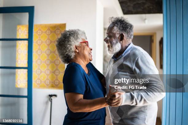 senior couple dancing at home - active lifestyle couple stock pictures, royalty-free photos & images