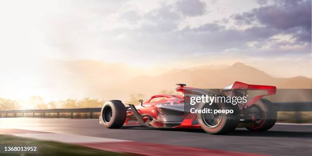 racing car moving at speed on racetrack at dawn - car engine close up stock pictures, royalty-free photos & images