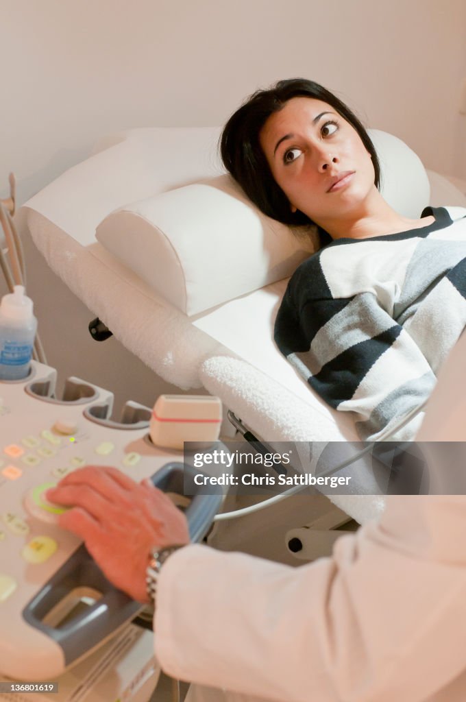 Hispanic woman having sonogram examination