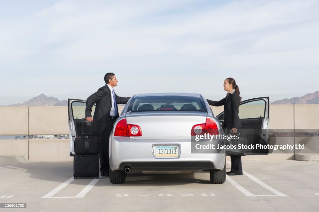 To Get In Business People Getting Into Car In Parking Lot High-Res Stock Photo ...