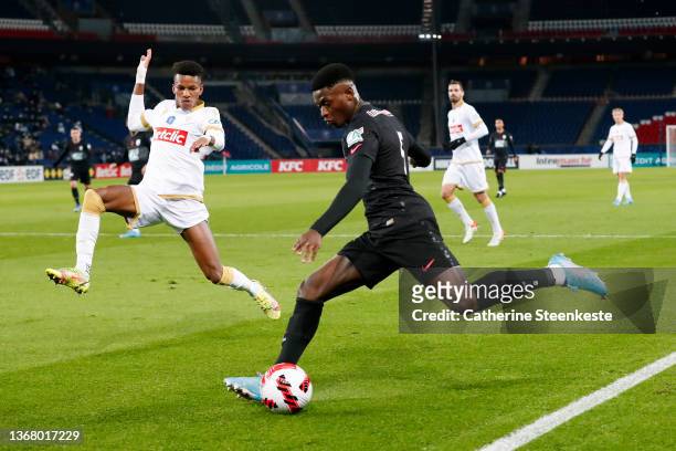 Nuno Mendes of Paris Saint-Germain shoots the ball against Hicham Boudaoui of OGC Nice during the French Cup match between Paris and Nice on January...
