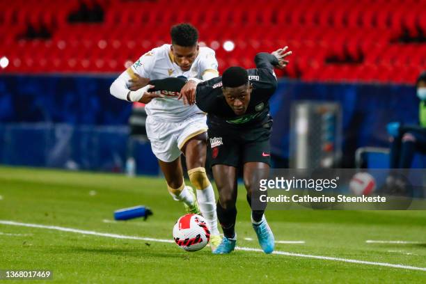 Hicham Boudaoui of OGC Nice challenges Nuno Mendes of Paris Saint-Germain during the French Cup match between Paris and Nice on January 31, 2022 in...