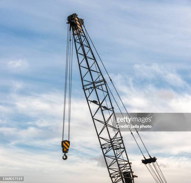industrial crane with hook photographed - crane hook stock-fotos und bilder