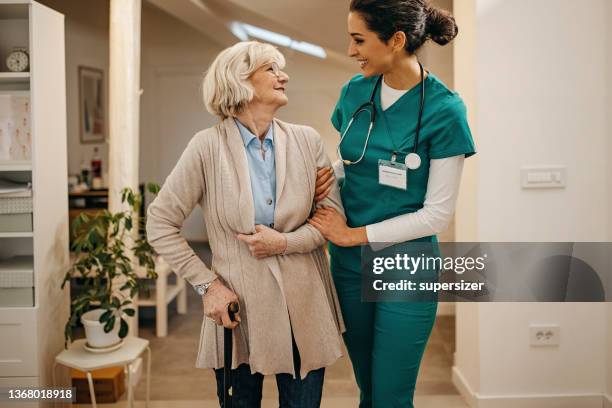 doctor in home visit to senior woman - patient safety stock pictures, royalty-free photos & images