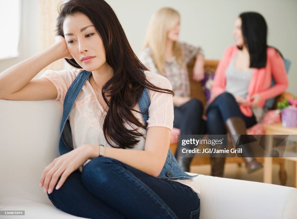 Sad woman isolated from friends