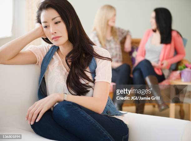 sad woman isolated from friends - social exclusion stock pictures, royalty-free photos & images