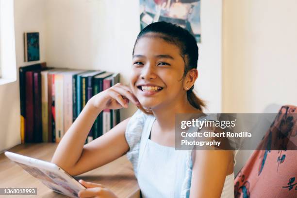 girl using tablet - daily life in philippines stockfoto's en -beelden