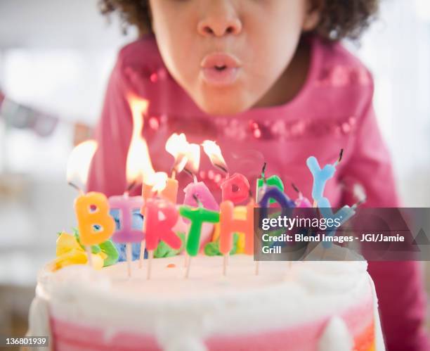 african american girl blowing out birthday candles - birthday candles 個照片及圖片檔