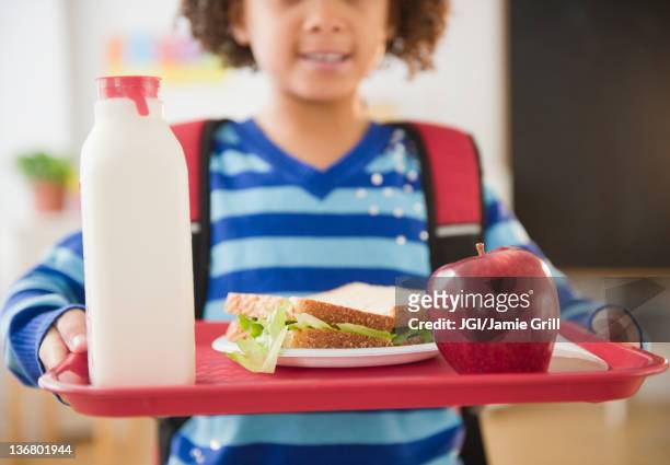 african american school girl holding lunch on a tray - cantina imagens e fotografias de stock