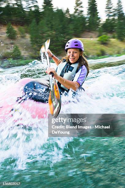 caucasian teenager kayaking in river - extreme kayaking stock pictures, royalty-free photos & images