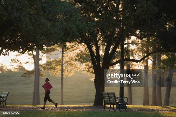 african american woman running in park - will houston fotografías e imágenes de stock