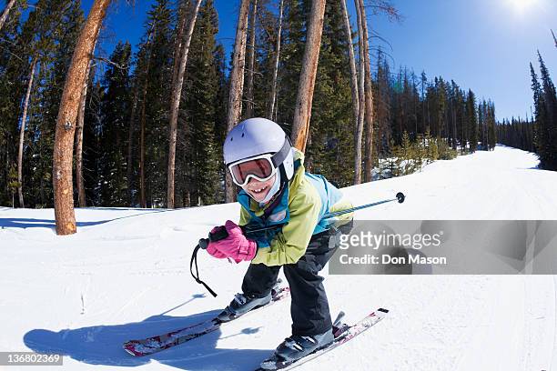mixed race girl skiing downhill - kids ski stock-fotos und bilder