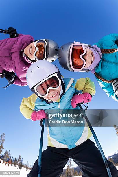 grinning family skiing together - family skiing bildbanksfoton och bilder