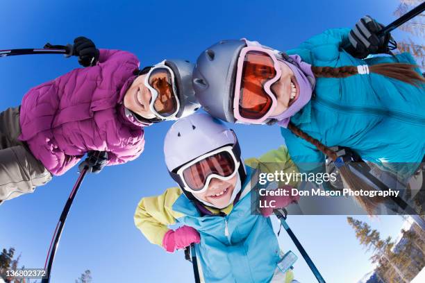 grinning family skiing together - kids sports equipment stock pictures, royalty-free photos & images