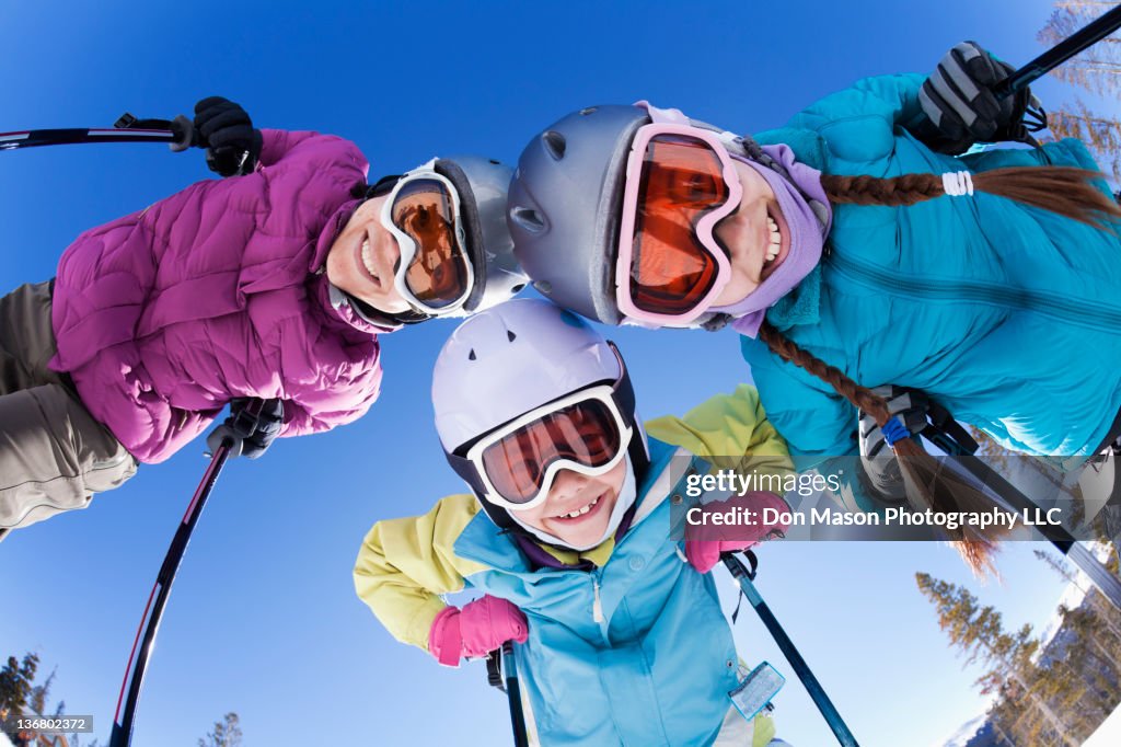 Grinning family skiing together