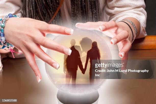 mixed race fortune teller with crystal ball with people inside - medium group of people foto e immagini stock