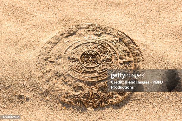 aztec calendar stone carving on sand - mayan stock pictures, royalty-free photos & images