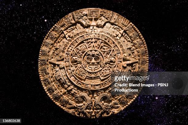 aztec calendar stone carving in space - aztec stock-fotos und bilder