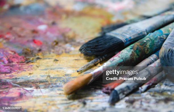 paintbrush, paintor paintbrushes - green colour palette stock pictures, royalty-free photos & images