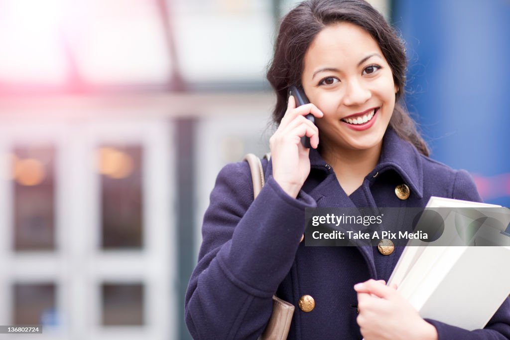 Mixed race woman talking on cell phone