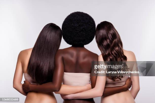 back rear view photo of three young attractive woman hug cuddle incognito anonym dander isolated over grey color background - haare stock-fotos und bilder