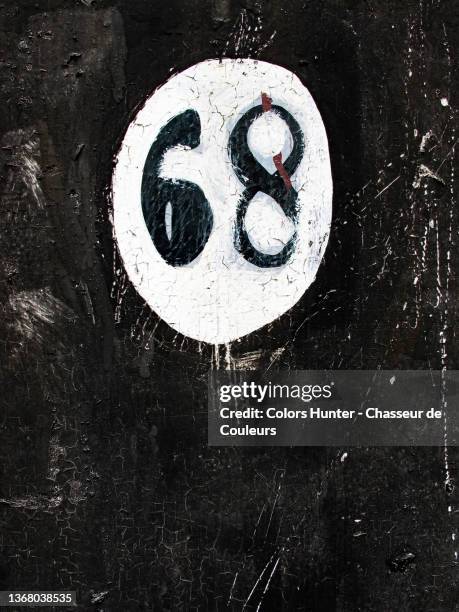 number 68 painted and patinated on a house facade in brussels. - numerology stock pictures, royalty-free photos & images