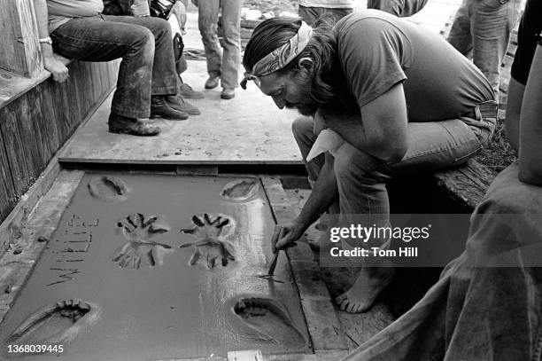 Country music singer-songwriter Willie Nelson promotes his "Red Headed Stranger" album at Peaches Records and leaves his footprints in concrete on...