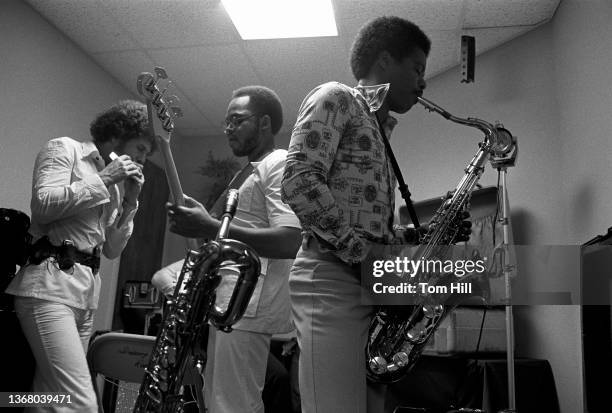 Harmonica player Lee Oskar, bassist B.B. Dickerson and saxophonist Charles Miller of funk, rock, and soul band War warm up in the dressing room...