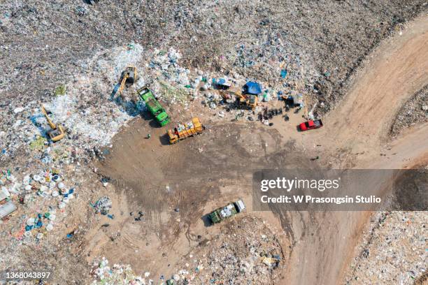 arriving of a garbage truck in a landfill - burying money stock pictures, royalty-free photos & images