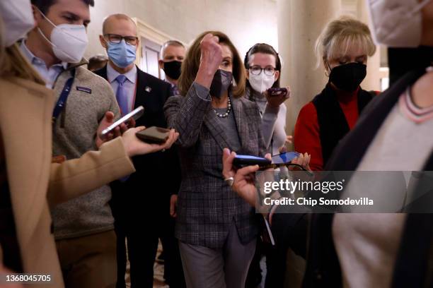 Speaker of the House Nancy Pelosi is surrounded by reporters as she returns to her office following a meeting with Senate Majority Leader Charles...