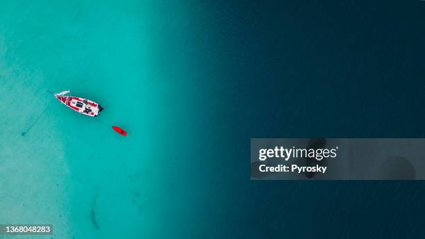 sailboat anchored next to the black cenote in bacalar, mexico. - yacht top view stock pictures, royalty-free photos & images