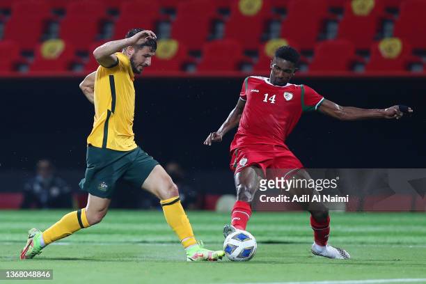 Mathew Leckie of Australia battles for possession with Amjad Al-Harthi of Oman during the FIFA World Cup Qatar 2022 Qualifier match between Oman and...