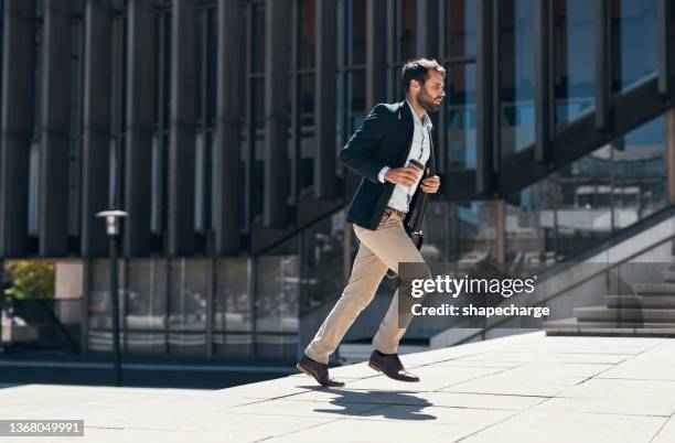 shot of a businessman running up a flight of stairs against an urban background - formal background stock pictures, royalty-free photos & images